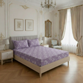 Neatly made bed with purple floral bedding in a stylish bedroom.