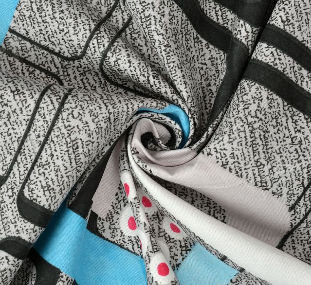 Close-up of patterned fabric with black, white, and blue design