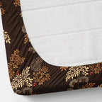 Brown floral-patterned fitted sheet on a white mattress