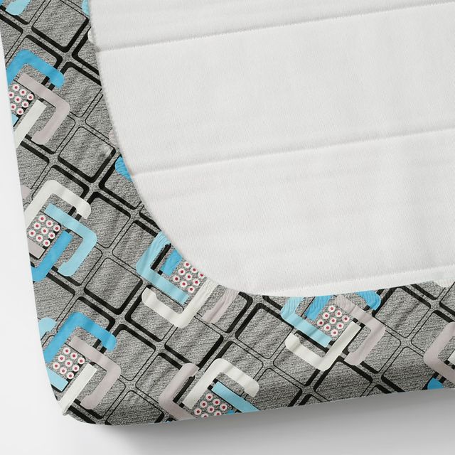 Fitted sheet with geometric pattern on a mattress