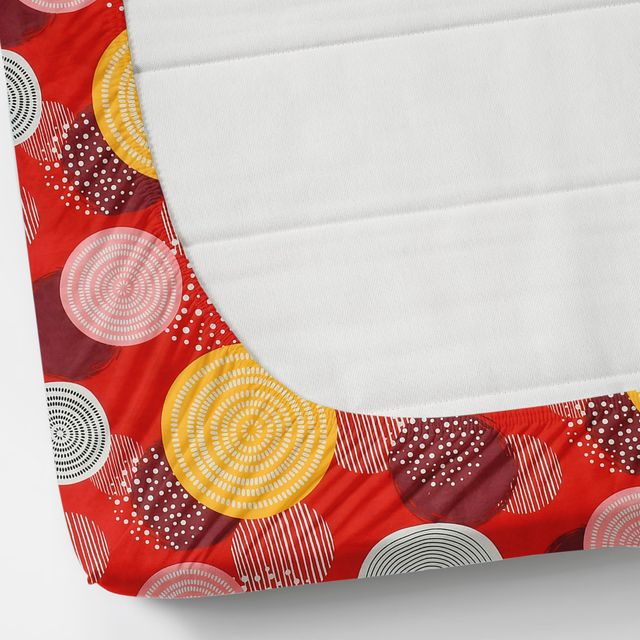 Red and yellow circular patterned fabric on a white background