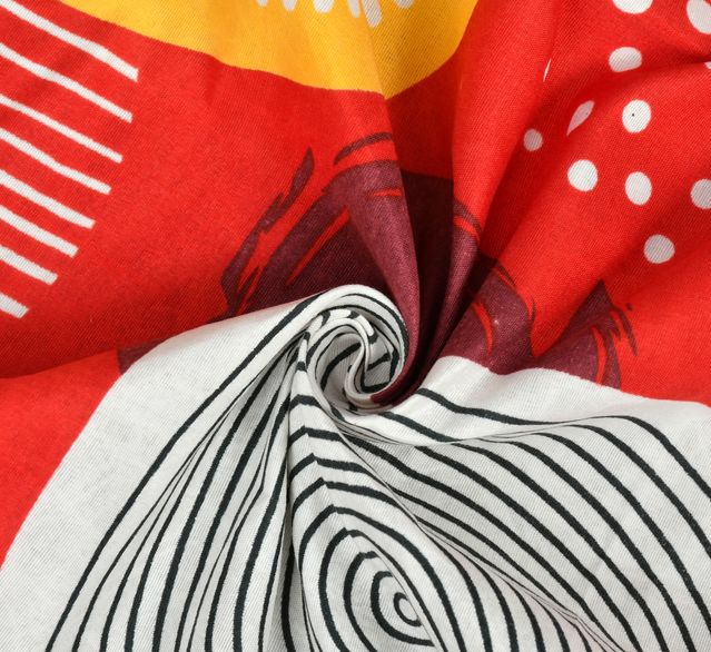 Close-up of fabric with red, yellow, white, and black patterns.